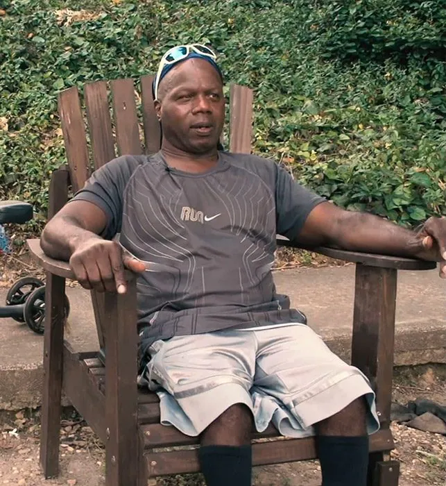 Skyy Adams sitting in a wooden chair outdoors