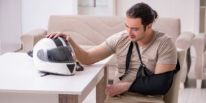 Young male motor-cyclist suffering at home after accident