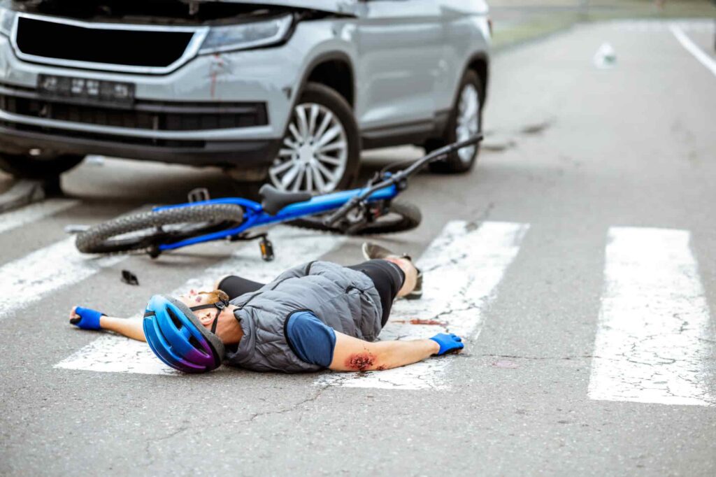 Bicycle accident with an injured cyclist on the road after a collision in Lawrenceville.