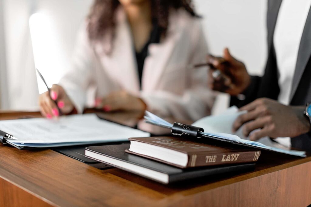 Lawyer reviewing accident case files with a client, emphasizing the group’s commitment to justice and results.