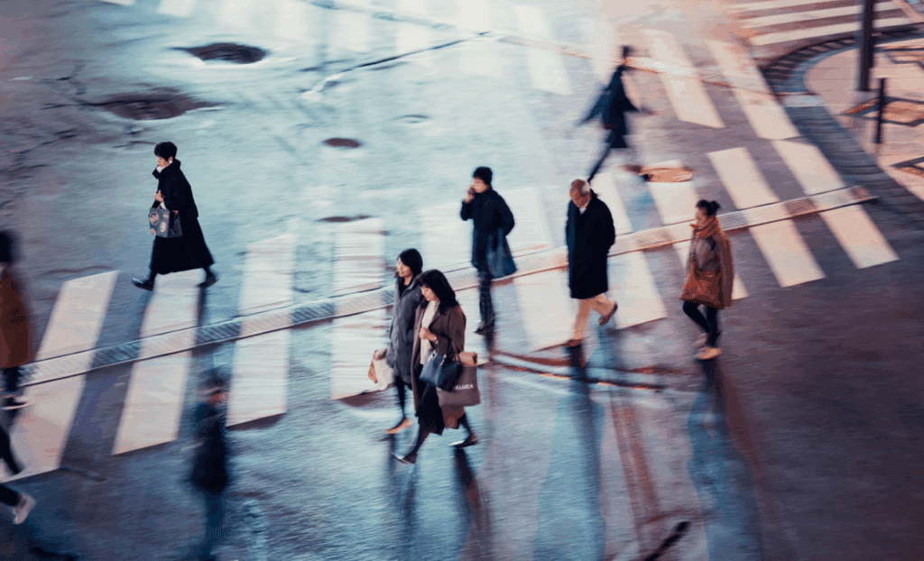 Pedestrians crossing crosswalk at night in Georgia.