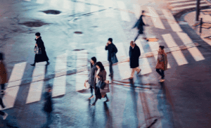 Pedestrians crossing crosswalk at night in Georgia.